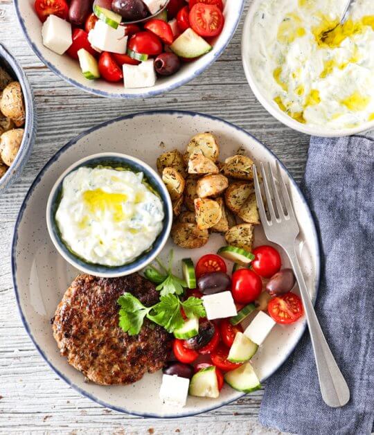 Image: GRESK HAKKEBIFF MED TZATZIKI, TOMATSALAT OG URTEBAKTE POTETER